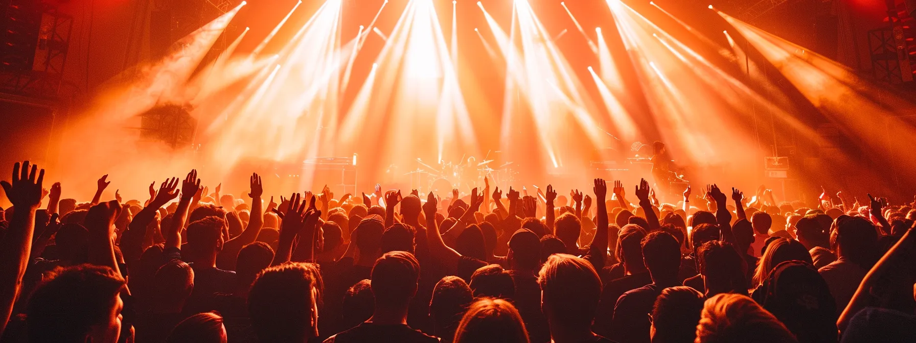 a vibrant concert scene captures a dynamic live performance, where an electrified crowd sways in unison under colorful lights, embodying deep audience engagement and community connection.